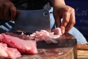 Raw pork chop on cutting board, pig shoulder butt meat cut out,Market of raw production.