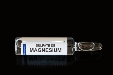 Close-up of magnesium sulfate vial against black background and copy space. Ideal for medical concept blogs or articles