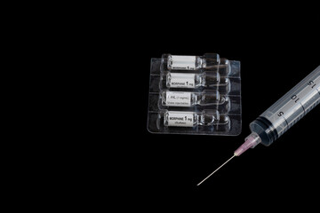 liquid morphine sulfate in glass vial for injections or infusion, alongside a syringe on black background. Ideal for medical presentations