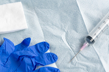 Blue glove and syringe