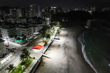 Obraz premium Guarujá city at night. View of Praia do Tombo and Praia das Asturias. Beaches on the coast of Santos.