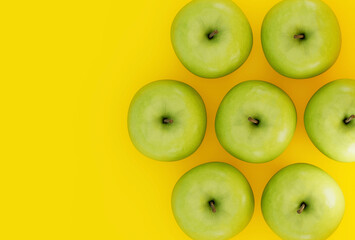 Green apples on yellow background. Delicious fruits in top view