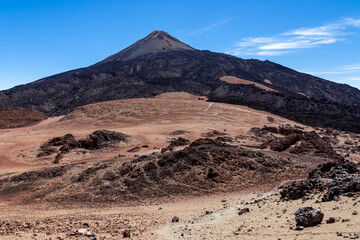 Hiking trail over volcanic desert terrain leading to summit of volcano Pico del Teide from Pico...