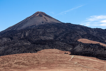 Hiking trail over volcanic desert terrain leading to summit of volcano Pico del Teide from Pico...