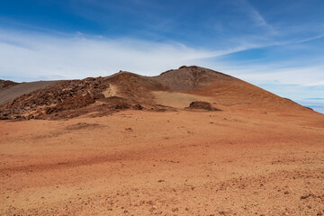 Hiking trail over volcanic desert terrain leading to summit of volcano Pico del Teide from Pico...
