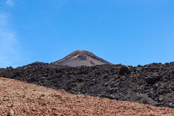 Hiking trail over volcanic desert terrain leading to summit of volcano Pico del Teide from Pico...