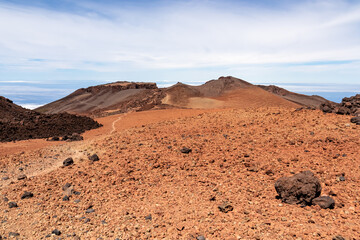 Hiking trail over volcanic desert terrain leading to summit of volcano Pico del Teide from Pico Viejo, Mount Teide National Park, Tenerife, Canary Islands, Spain, Europe. Solidified lava, ash, sand