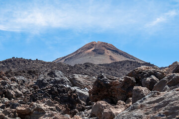 Hiking trail over volcanic desert terrain leading to summit of volcano Pico del Teide from Pico...