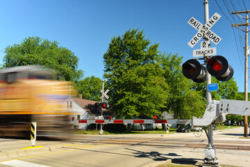 Freight train in motion speeding through crossing gate