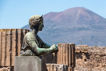 POMPEII, ITALY - MAY 04, 2022 - Colonnade and sculptures of the Temple of Apollo near the Pompeian forum, Italy