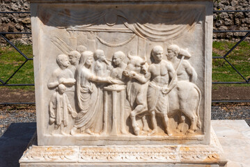 POMPEII, ITALY - MAY 04, 2022 - fresco on an ancient marble altar in the Roman city of Pompeii,...