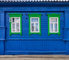 The beautiful old windows with beautifully designed platbands window on an old wooden house in Semenov city. Nizhny Novgorod Region, Russia.