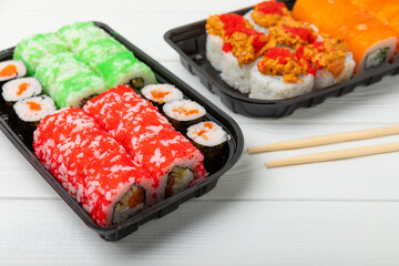 Assorted sushi. Big set of sushi. A variety of Japanese sushi with crab, salmon, eel and caviar on a white wooden table. Top viewCopy space. food delivery
