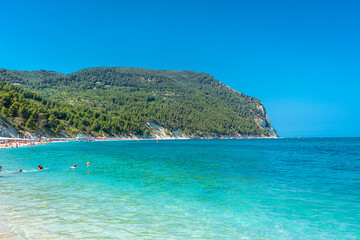 Naklejka premium SIROLO, ITALY, 23 JULY 2021 Tourists on Urbani Beach down the Conero Mount in the Marche Region