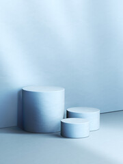 Three blue various sized empty cylindrical pedestals. 3d computer graphic template of displaying place for your products. Blank template.