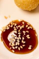 a drop of sauce with sesame seeds