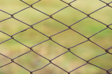 Metal mesh with traces of corrosion close-up on a natural background. Abstract background with repeating elements.