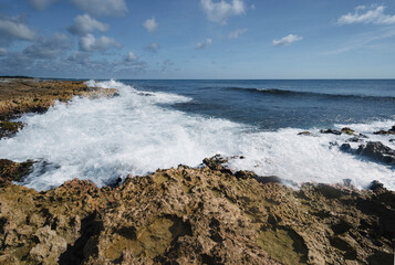 Closeup of waves crashing on rocks with copy space