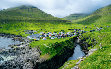 Natural harbour gorge nearby idyllic village Gjogv. Eysturoy Island on the Faroe Archipelago. It is...