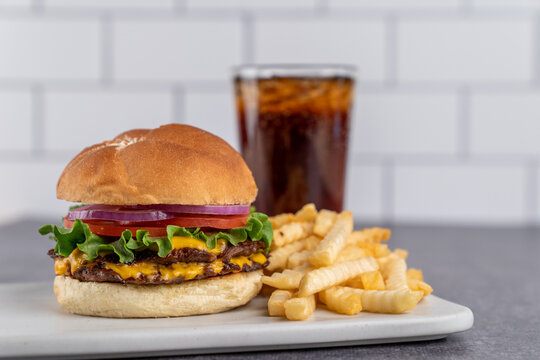 Double hamburger with cheese with fries and a drink 