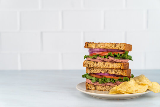 Deli sandwich with drink on a light surface