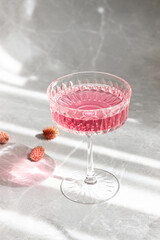 pink cocktail in glass on marble table