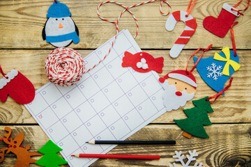 Christmas composition with a glider or calendar .Flat felt handmade toys. Red mittens, felt Santa,...