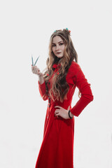 a girl in a red dress on a white background poses