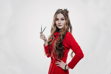 a girl in a red dress on a white background poses