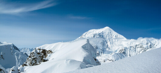 Fototapeta na wymiar View of Mount Foraker from an adjacent peak with snow, hanging glaciers, rock, blue sky, no people