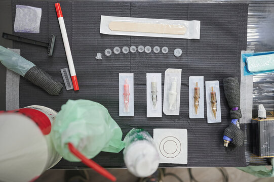 Tattoo studio scene. Set of different sterilized needles on the work table of a tattoo artist to use in a design tattooed on the skin.