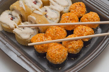 japanese cuisine, hot rolls with chopsticks
