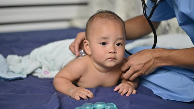 Asian baby patient in hospital with pediatrician