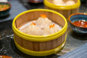 Dim Sum in bamboo steamer, Chinese cuisine. Closeup rustic style. horizontal. Selective focus