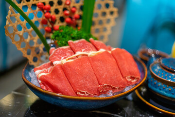 Raw beef slice for hot pot, fresh snowflake beef slices, chinese food. Selective focus.