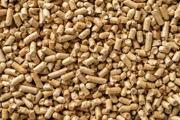 Wood pellets background. Texture of compacted sawdust granules. Ecological biofuel made from...