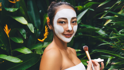 Dayspa weekend procedures - Korean teen girl applying face clay mask doing cosmetic procedures at...