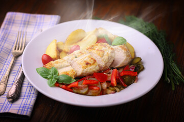 delicious grilled chicken breast served with grilled vegetables