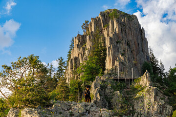 Mountain range of Rhodope Mountains covered with vegetation against the backdrop of valley covered with spruce forests © YouraPechkin