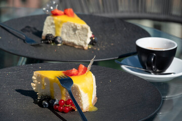 Cheesecakes with berries in a street restaurant