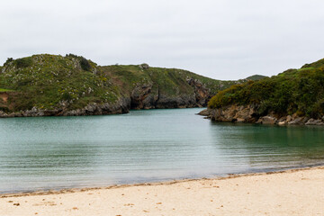 Fototapeta na wymiar Northern Spain beach, beautiful sea, next to cliffs and rocks on the shore