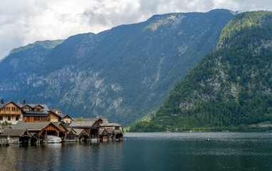 Fototapeta premium Panoramic view of the famous old town of Hallstatt and its jetty and the deep blue lake in summer, Salzkammergut, Austria