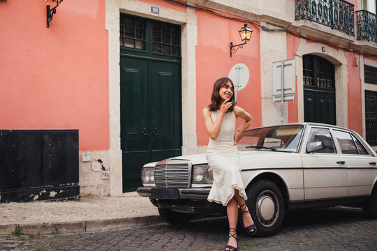 Content Woman Near Retro Car In City