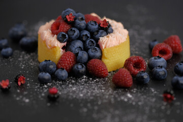 Cake with cream covered with juicy berries.