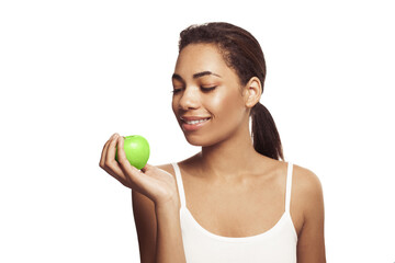 Cute young woman with beautiful smile holding green apple. Healthy lifestyle, nutrition, dieting, weight loss,  dental care and healthy teeth conсept.