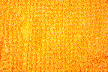 Orange fiber fabric texture. Background of a rag of orange cloth for cleaning....
