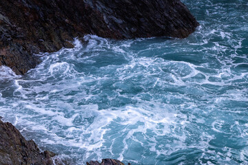 Northern Spain beach, beautiful sea, next to cliffs and rocks on the shore