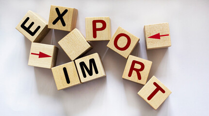 text Import, export and pointers written on wooden blocks and white background