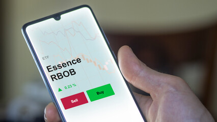 Un investisseur analyse un fonds etf essence rbob sur un graphique. Un téléphone affiche le cours de l'ETF. Texte en français francais Essence RBOB