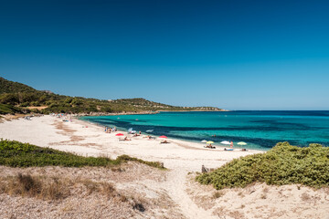 Holidaymakers enjoy the turquoise Mediterranean sea at Bodri beach in the Balagne region of Corsica